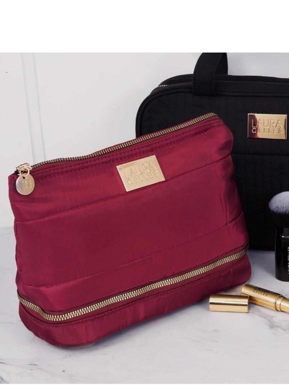 This is a burgundy, quilted nylon Laura Geller New York makeup bag